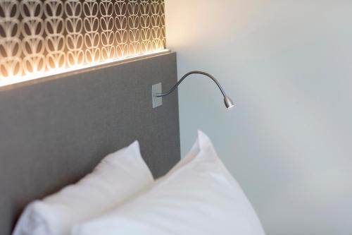 Cama o camas de una habitación en ibis Styles Kortrijk Expo
