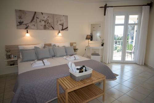 a bedroom with a bed and a table with a basket on it at Marina's House in Parga