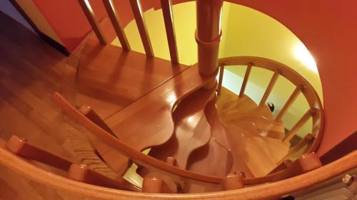 a wooden spiral staircase with a glass railing at Holiday Home Ploski in Herceg-Novi