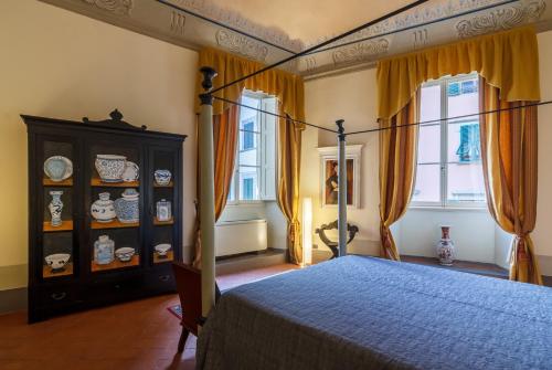Postel nebo postele na pokoji v ubytování Dimora Storica Palazzo Puccini