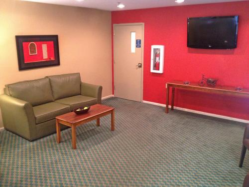 a living room with a couch and a table and a tv at Extended Stay America Suites - Birmingham - Wildwood in Birmingham
