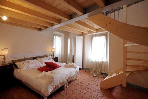 a bedroom with a large bed and a staircase at Guest House Al Castello in Gravedona