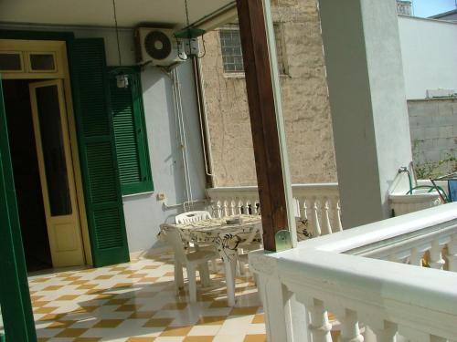 a balcony of a house with a table and chairs at Palazzo Lagioia in Triggiano