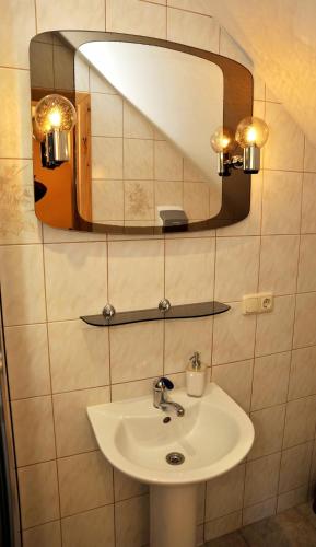 a bathroom with a sink and a mirror at Pakrantė in Klaipėda