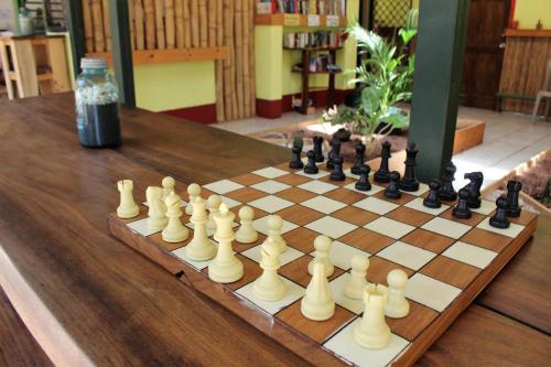 a chess board with chess pieces on a wooden table at Indra Inn in Playa Grande