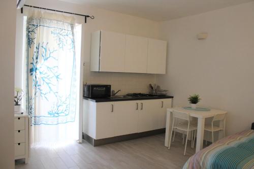 A kitchen or kitchenette at Graziella House Holiday