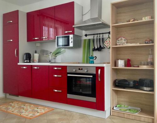 cocina con armarios rojos y fogones en Holiday Home Julian Alps, en Bovec