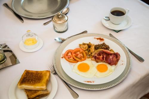 a plate of breakfast food with eggs and toast at AnnVilla Guesthouse in Klerksdorp