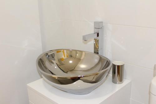 a bowl sink sitting on a shelf in a bathroom at Bracara Guest House "Bom Jesus" in Braga