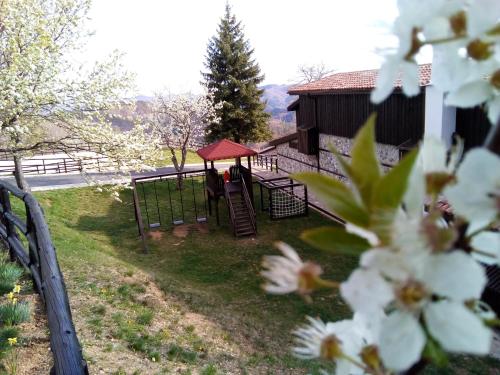 a playground in front of a building with a slide at Panorama Family Hotel in Zlatograd
