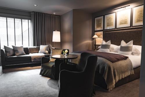 a hotel room with a bed and a couch at Dakota Leeds in Leeds