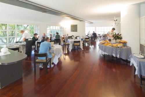 a restaurant with people sitting at tables in a room at Locanda Dell'Angelo in Ameglia