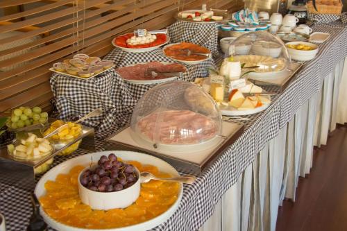 a buffet with many plates of food on a table at Locanda Dell'Angelo in Ameglia