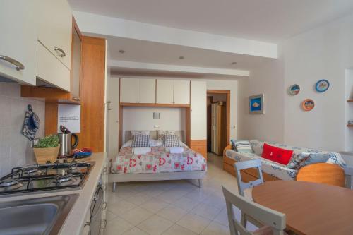 a kitchen and living room with a bed and a couch at Appartamento Buranco in Monterosso al Mare