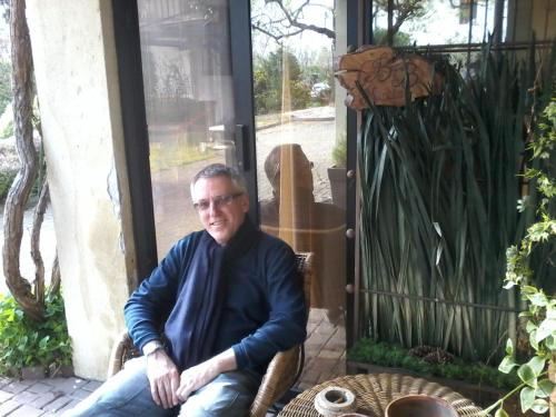 a man sitting in a chair in front of a door at Bed and Breakfast Miotto in Montegalda