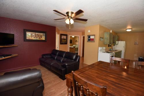 a living room with a couch and a dining room table at River Bluff Cabins in Rio Frio
