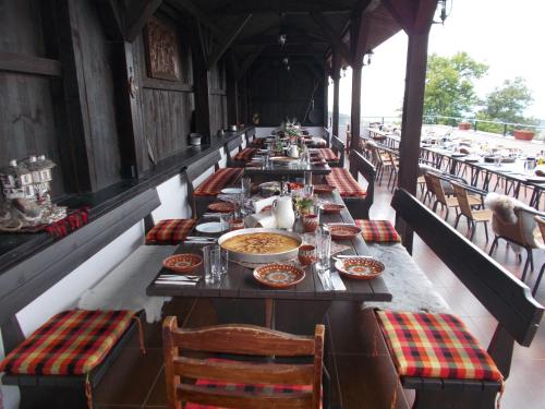a long table with plates of food on it at Panorama Family Hotel in Zlatograd