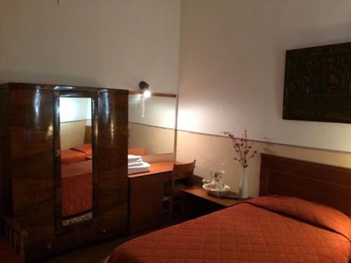 
a hotel room with a bed and a television at Hotel Acropolis in Kavála
