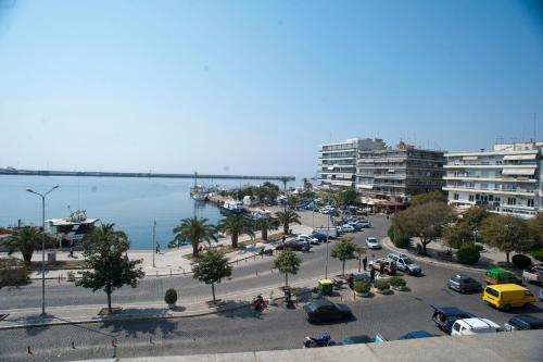 a city with a parking lot next to the ocean at Hotel Acropolis in Kavala