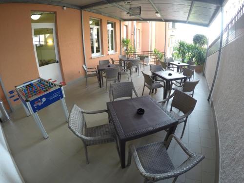 an empty restaurant with tables and chairs in a building at Albergo Esperia in Tabiano