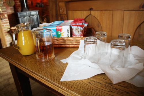 a table with three glasses and a basket of drinks at The Ram at Tivetshall in Tivetshall Saint Margaret