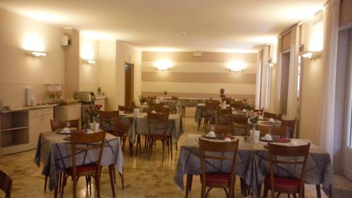 a dining room with tables and chairs in it at Primavera in Levanto