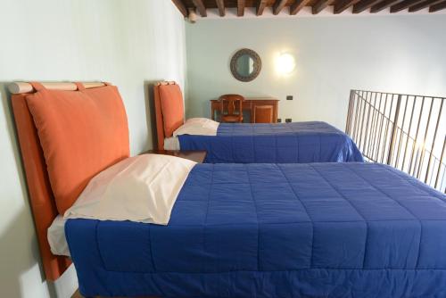Posteľ alebo postele v izbe v ubytovaní Appartamenti Medioevo