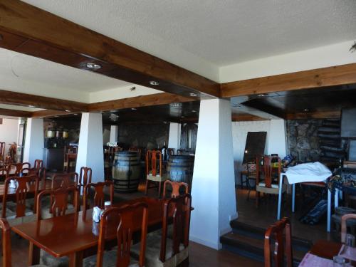 a dining room with wooden tables and chairs at Hotel HF in Farellones