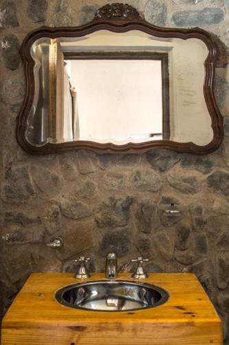 a bathroom with a sink and a mirror at Chakana Hospedaje Rural in Villa Unión