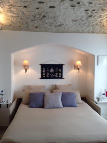 a bedroom with a large bed with blue pillows at KAMBUSA LOFT - Mono fronte mare in Santo Stefano al Mare