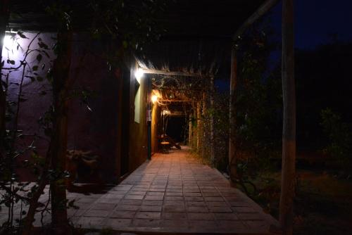 an alley way at night with a lit up tunnel at Chakana Hospedaje Rural in Villa Unión