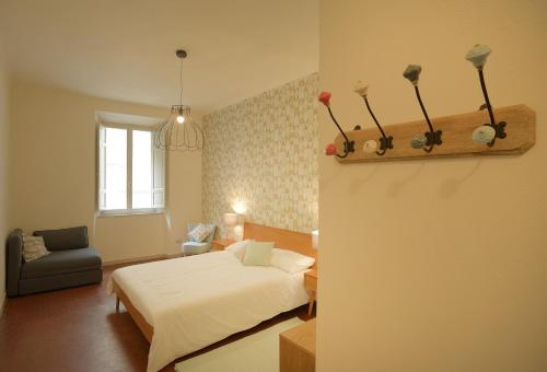 a bedroom with a bed and a chair in it at Le camere di Sementis in Pietrasanta