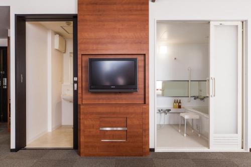 a room with a door with a tv on it at MYSTAYS Shin Urayasu Conference Center in Urayasu