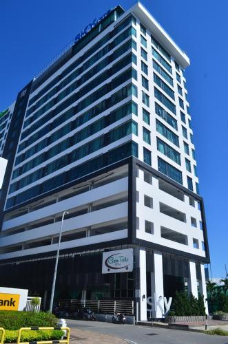 a large building with a sign in front of it at Cozy Living Sky Apartment in Kota Kinabalu