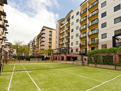 a tennis court in front of some apartment buildings at Nesuto Mounts Bay in Perth