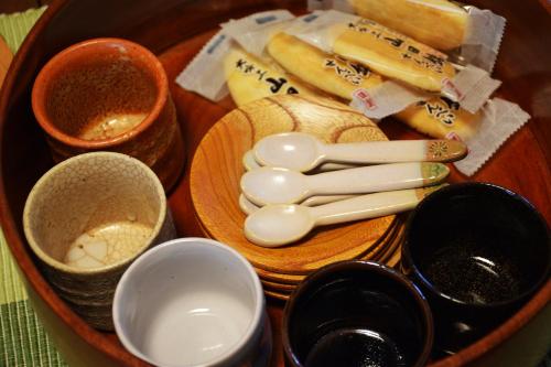 a tray of food with utensils and other ingredients at Guesthouse Chayama in Kyoto
