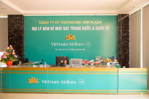a reception desk with a sign on a wall at Vinh Plaza Hotel in Vinh