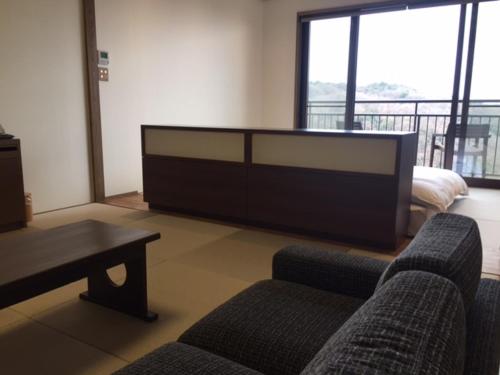 a living room with two couches and a coffee table at Kakimotoya in Sango