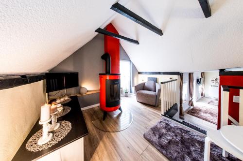 a living room with a wood stove in the ceiling at harz-traum in Gernrode - Harz