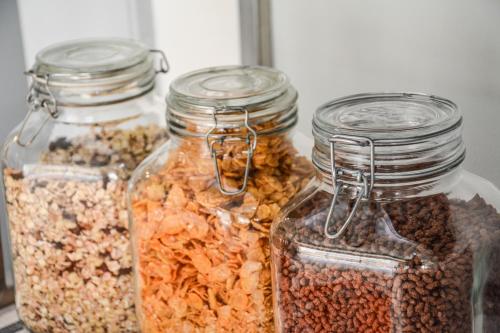 a group of three glass jars filled with nuts at Hotel Aurora & Appartamenti in Nago-Torbole