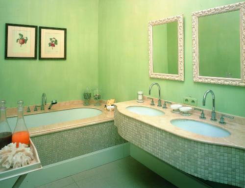 a bathroom with two sinks and two mirrors at Hotel Recour in Poperinge