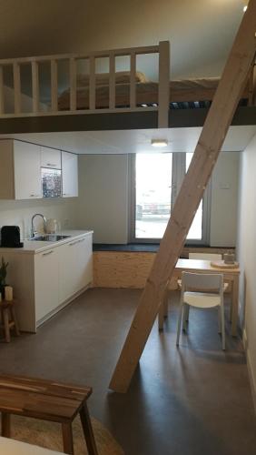 a kitchen with a loft bed and a kitchen with a table at Terrace Apartment Cyclades Free Parking in Amsterdam