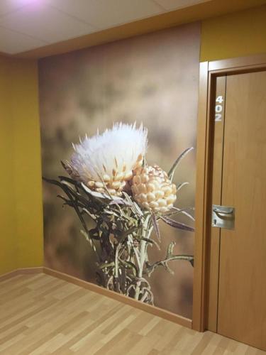 a painting of a white flower on a wall at Mirador El Silo in Bello