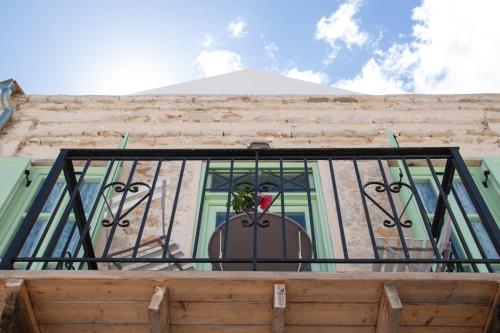 a balcony with a window with a plant on it at Villa Klytia in Halki