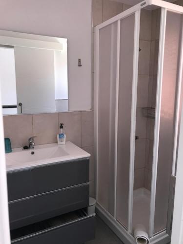 a bathroom with a sink and a shower at Vista Faro 39 in Maspalomas