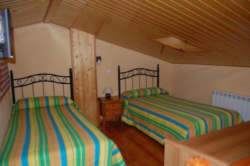 A bed or beds in a room at Gredos Casa Rural Los Treboles