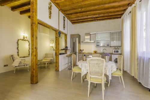 a kitchen and dining room with a table and chairs at Oriente Palace Apartments in Madrid