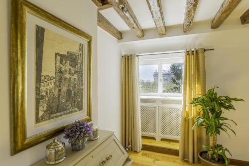 a room with a painting on the wall and a window at Oriente Palace Apartments in Madrid