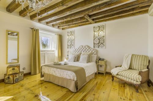 a bedroom with a bed and a chair at Oriente Palace Apartments in Madrid