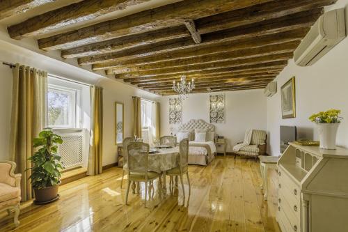 a living room with a table and chairs at Oriente Palace Apartments in Madrid